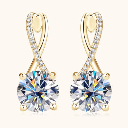 Close-up of round-cut Moissanite stone on 14k gold drop earrings